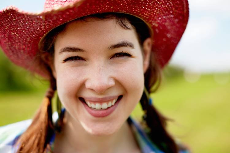 a-young-woman-in-a-pink-straw-hat-smiling-broadly-2025-04-04-08-31-38-utc