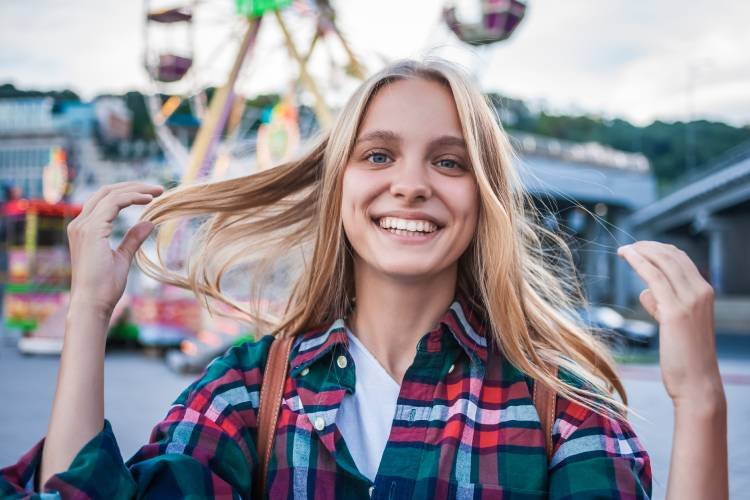 happy-blonde-girl-smiling-at-camera-while-spending-2024-11-13-14-21-28-utc